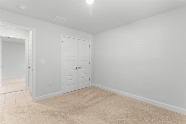 unfurnished bedroom featuring a closet and carpet floors