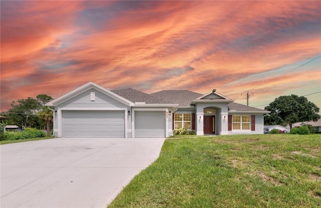 ranch-style home featuring a garage and a front lawn