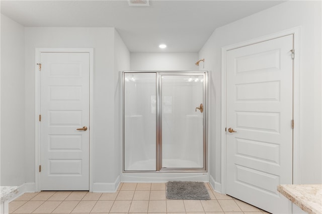 bathroom featuring tile patterned floors, walk in shower, and vanity