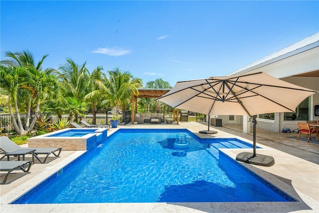 view of pool with a patio and an in ground hot tub