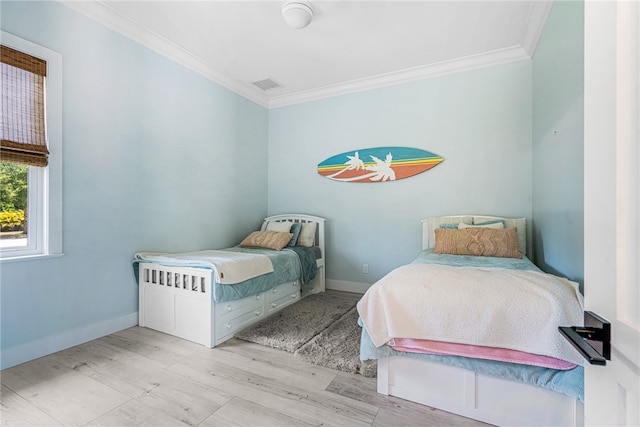 bedroom with light hardwood / wood-style floors and ornamental molding