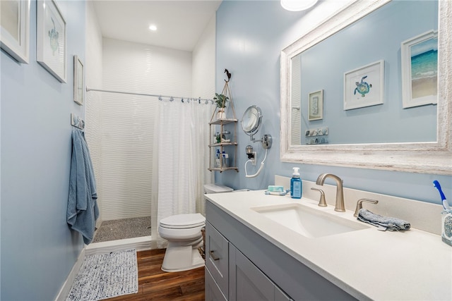 bathroom with toilet, vanity, hardwood / wood-style flooring, and a shower with shower curtain