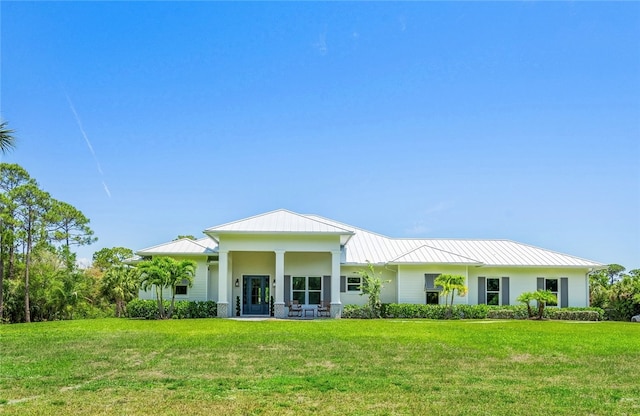 rear view of property with a yard