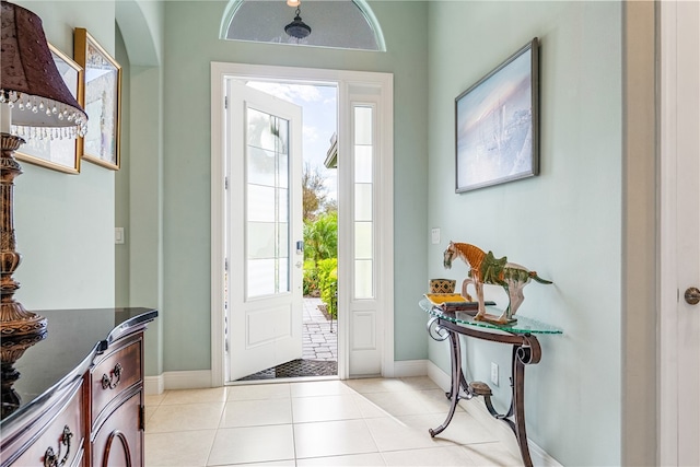 foyer entrance with a healthy amount of sunlight and light tile patterned floors