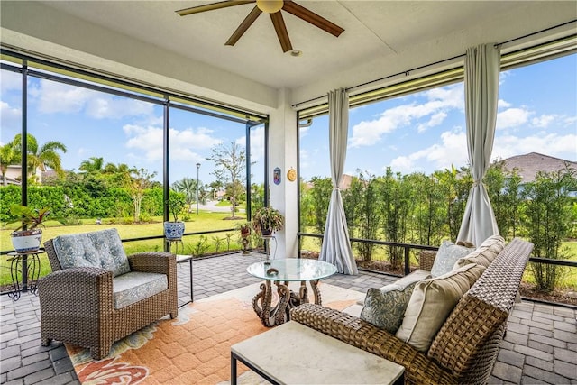 sunroom featuring ceiling fan