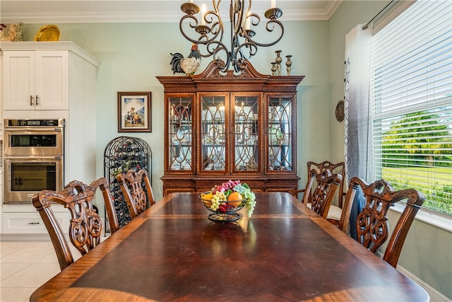 tiled dining space featuring ornamental molding and a chandelier