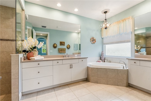 bathroom with tile patterned flooring, vanity, independent shower and bath, and a notable chandelier