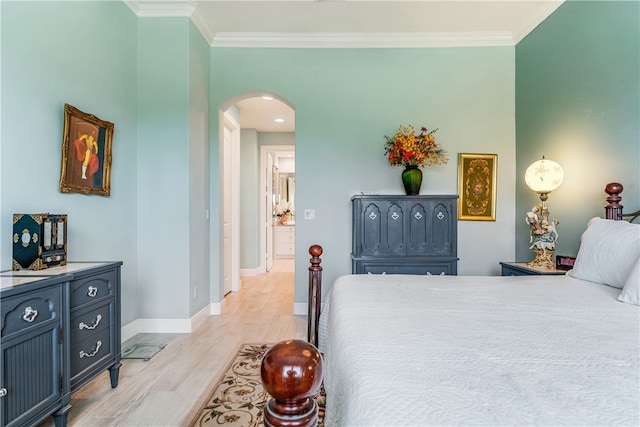 bedroom featuring crown molding and light hardwood / wood-style floors