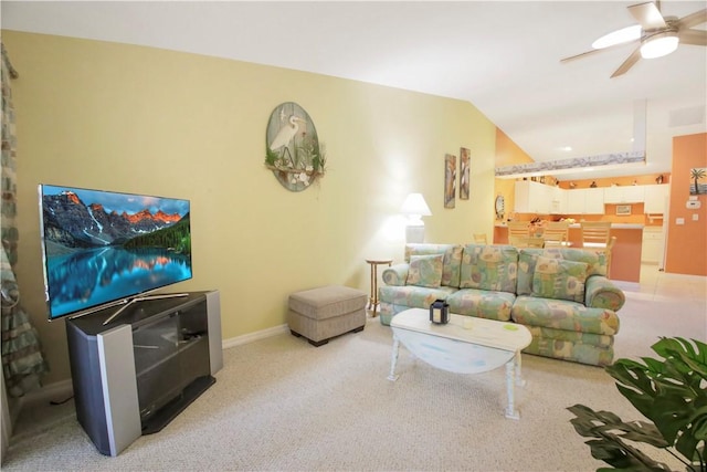 carpeted living room with ceiling fan and lofted ceiling