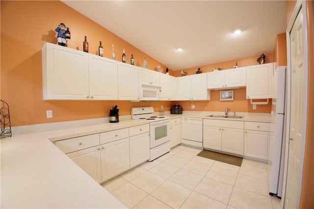 kitchen featuring white cabinetry, sink, and white appliances