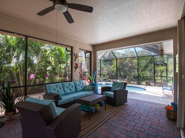 sunroom with a swimming pool and ceiling fan