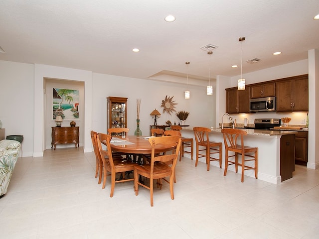 dining room with a textured ceiling and sink