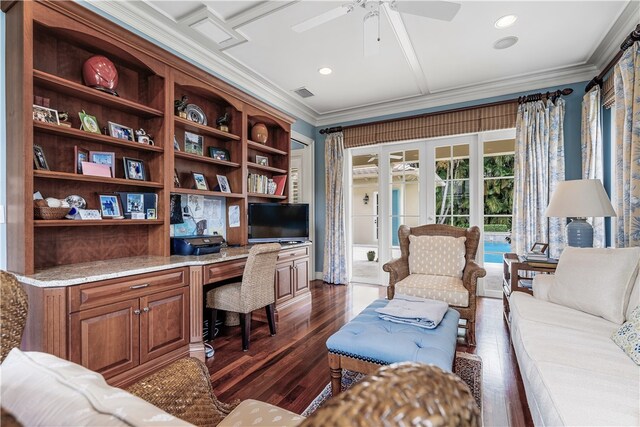 office space with built in desk, ceiling fan, crown molding, and dark hardwood / wood-style flooring