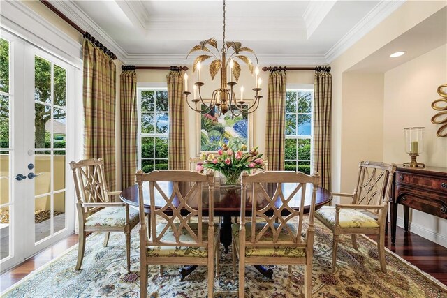 410 N Palm Island Cir, Vero Beach, FL 32963 - dining area with a chandelier, wood finished floors, plenty of natural light, and ornamental molding