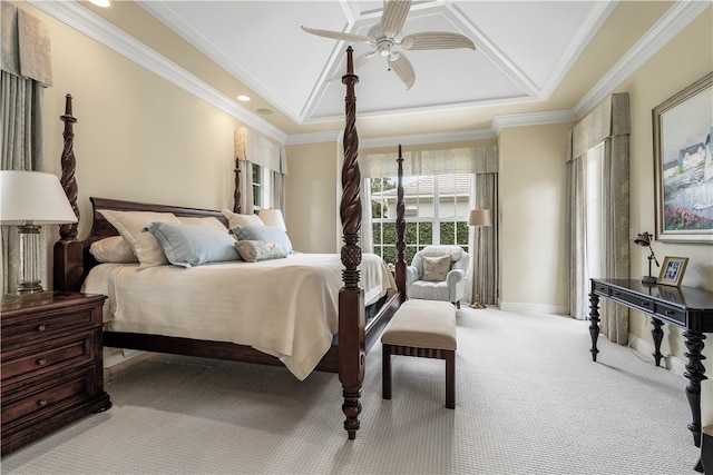 carpeted bedroom featuring a tray ceiling, ceiling fan, and crown molding