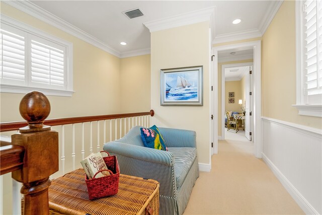 sitting room with light carpet and crown molding