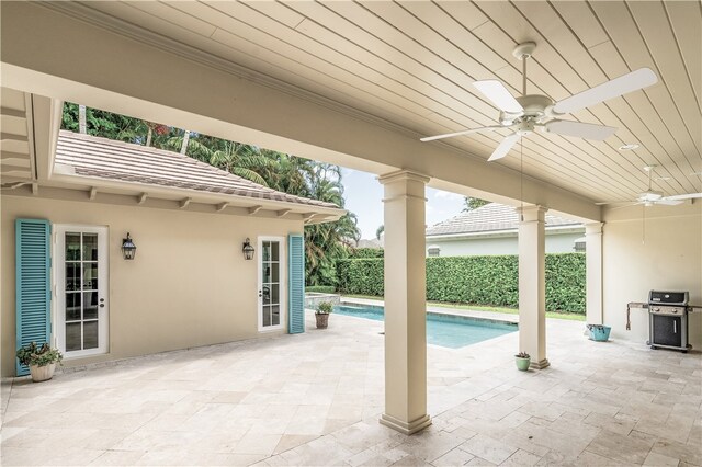 view of pool featuring a patio, area for grilling, and ceiling fan