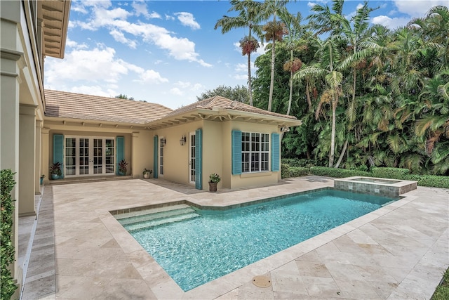 view of swimming pool featuring a patio area, french doors, and an in ground hot tub