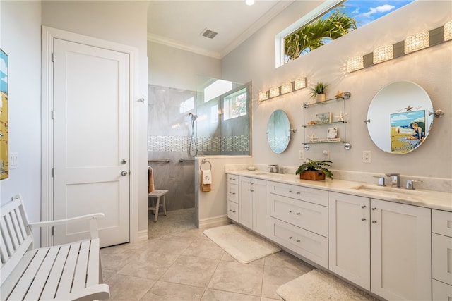 bathroom featuring ornamental molding, tiled shower, vanity, and tile patterned floors