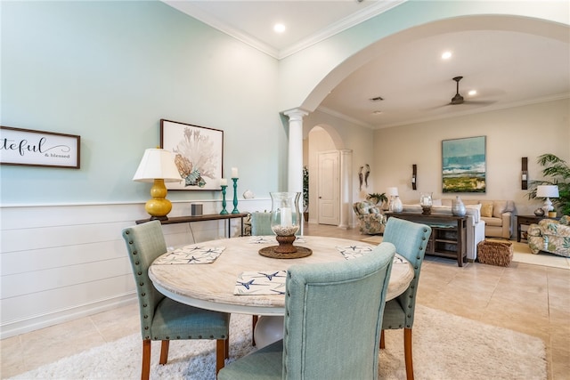 tiled dining space with ceiling fan, crown molding, and decorative columns