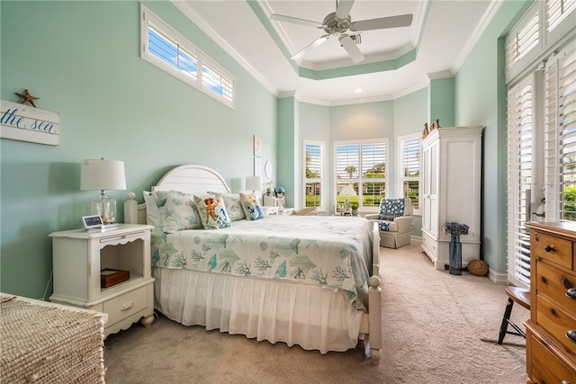 carpeted bedroom featuring a raised ceiling, crown molding, a high ceiling, and ceiling fan