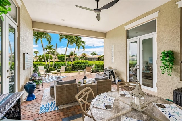 view of patio / terrace featuring french doors, ceiling fan, a grill, and an outdoor hangout area