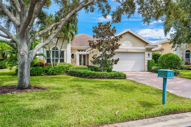 view of front facade with a front lawn and a garage