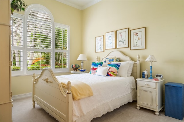 carpeted bedroom featuring multiple windows and crown molding