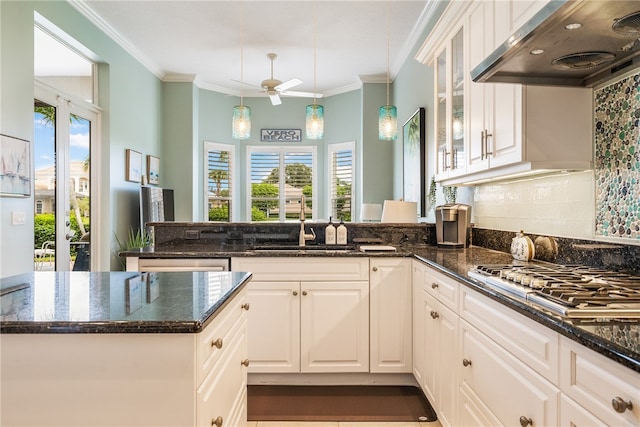 kitchen featuring white cabinetry, custom range hood, dark stone countertops, and stainless steel gas cooktop