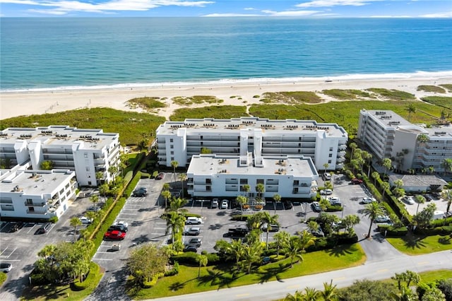 birds eye view of property with a water view and a view of the beach