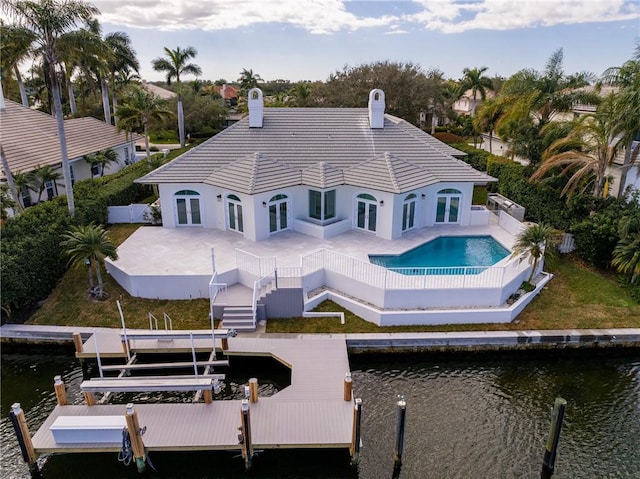 back of property featuring a patio and a water view