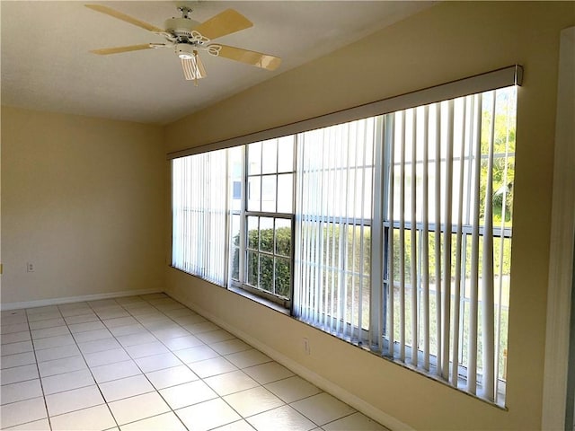 unfurnished sunroom with ceiling fan