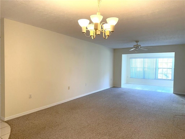 spare room with ceiling fan with notable chandelier, carpet floors, and a textured ceiling