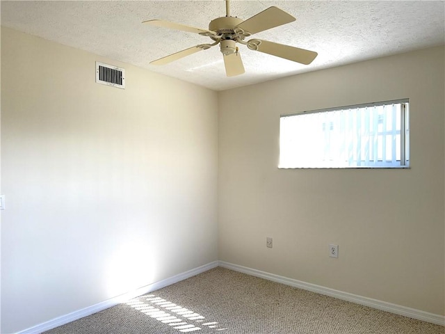 spare room featuring ceiling fan, a textured ceiling, and carpet flooring