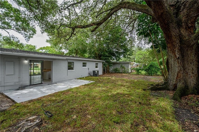 2313 2nd St SW, Vero Beach, FL 32962 - view of grassy yard with a patio and central AC unit