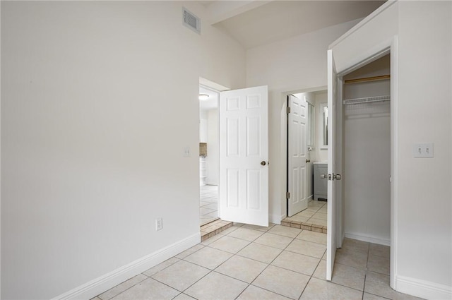 2313 2nd St SW, Vero Beach, FL 32962 - unfurnished bedroom with light tile patterned flooring, a closet, and baseboards