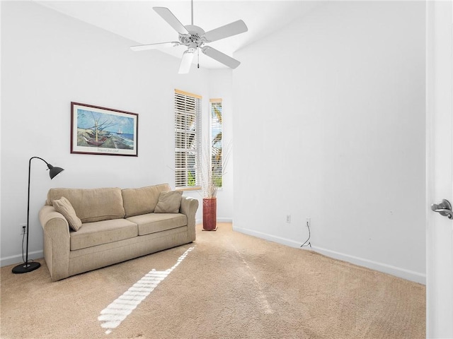 carpeted living room featuring ceiling fan