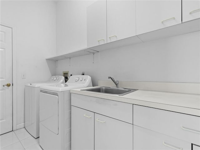 washroom featuring washer and dryer, light tile patterned flooring, cabinets, and sink