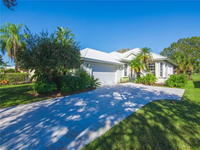 single story home with a front lawn and a garage