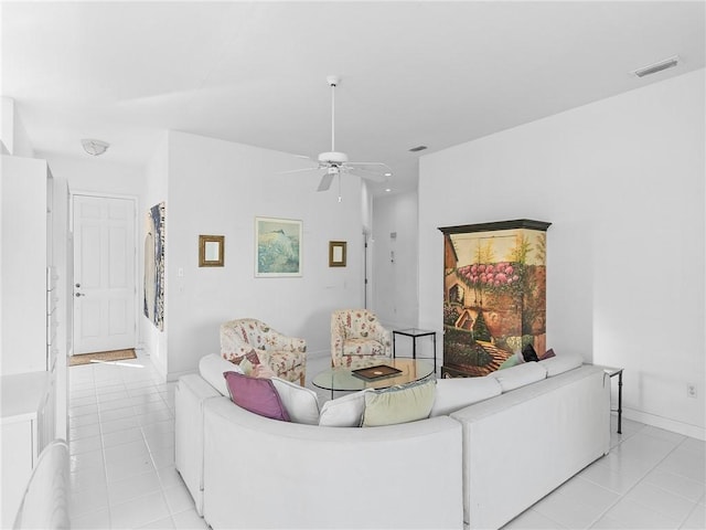 tiled living room featuring ceiling fan