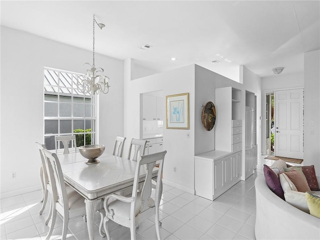 tiled dining area with a notable chandelier