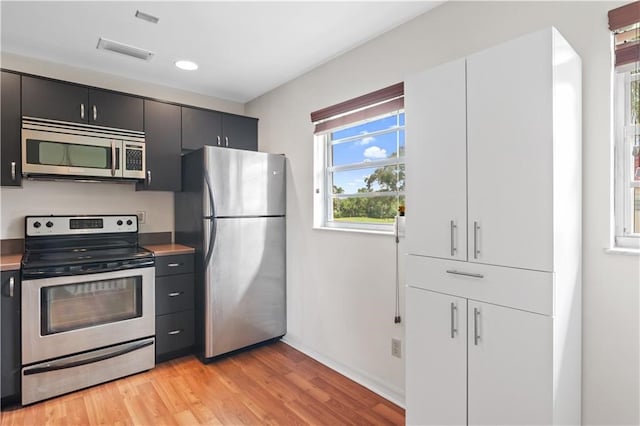 kitchen with light wood-type flooring and appliances with stainless steel finishes