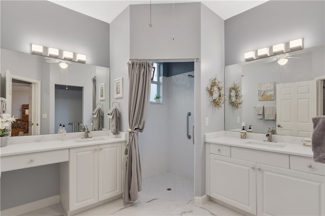 bathroom featuring ceiling fan, vanity, and a tile shower