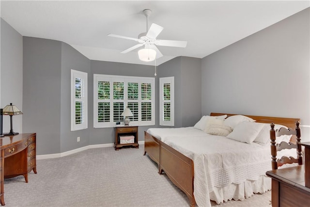 bedroom with light carpet, baseboards, and a ceiling fan