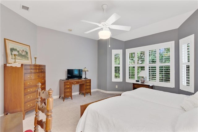 bedroom featuring light carpet, baseboards, lofted ceiling, and a ceiling fan