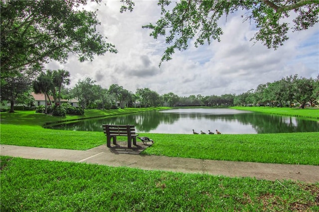 view of community with a yard and a water view