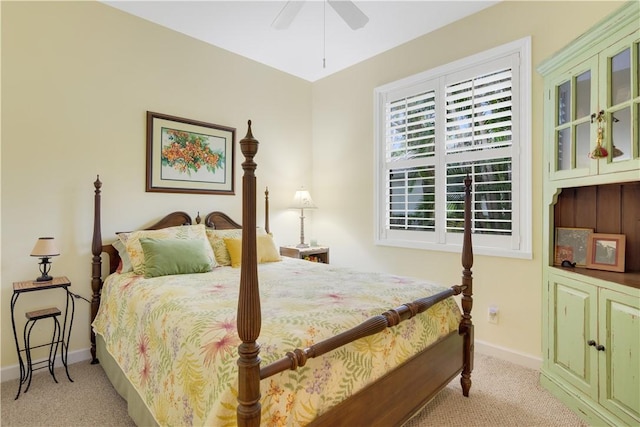 bedroom featuring light carpet, baseboards, and a ceiling fan