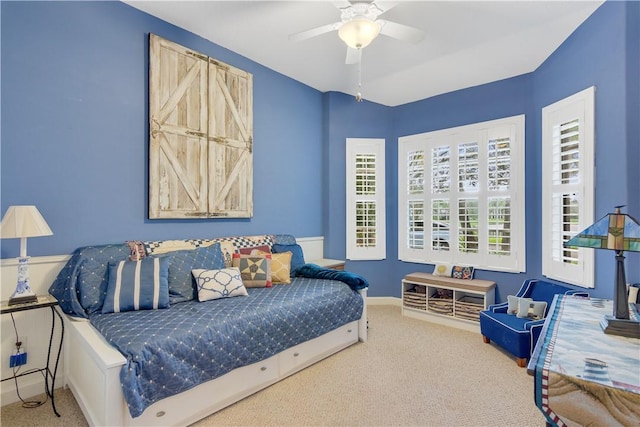 bedroom with carpet, ceiling fan, and baseboards