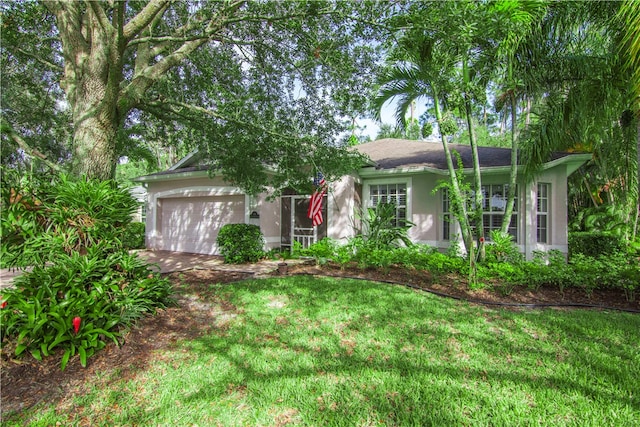 view of front facade with a garage and a front yard