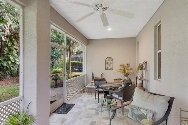 sunroom featuring ceiling fan